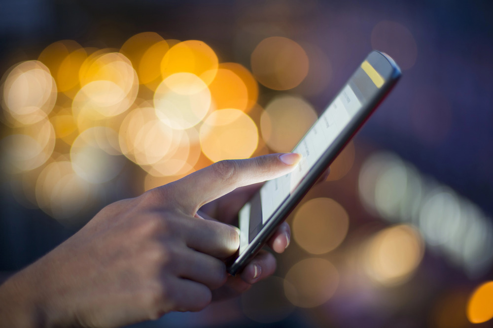 Finger touching smartphone screen
