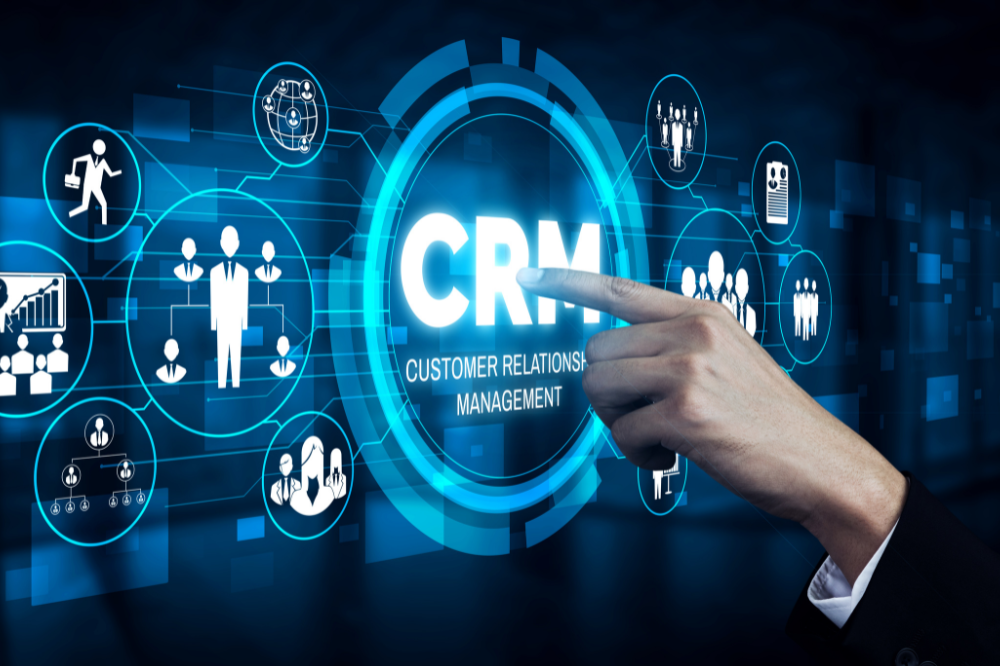 Finger touching screen with CRM words on it